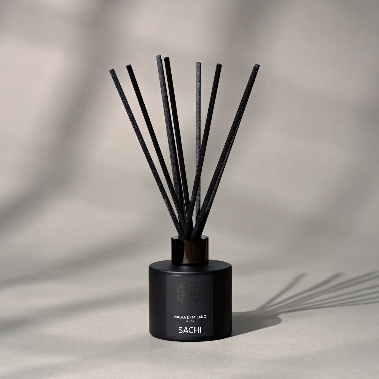 Black Sachi diffuser with reeds on a neutral background