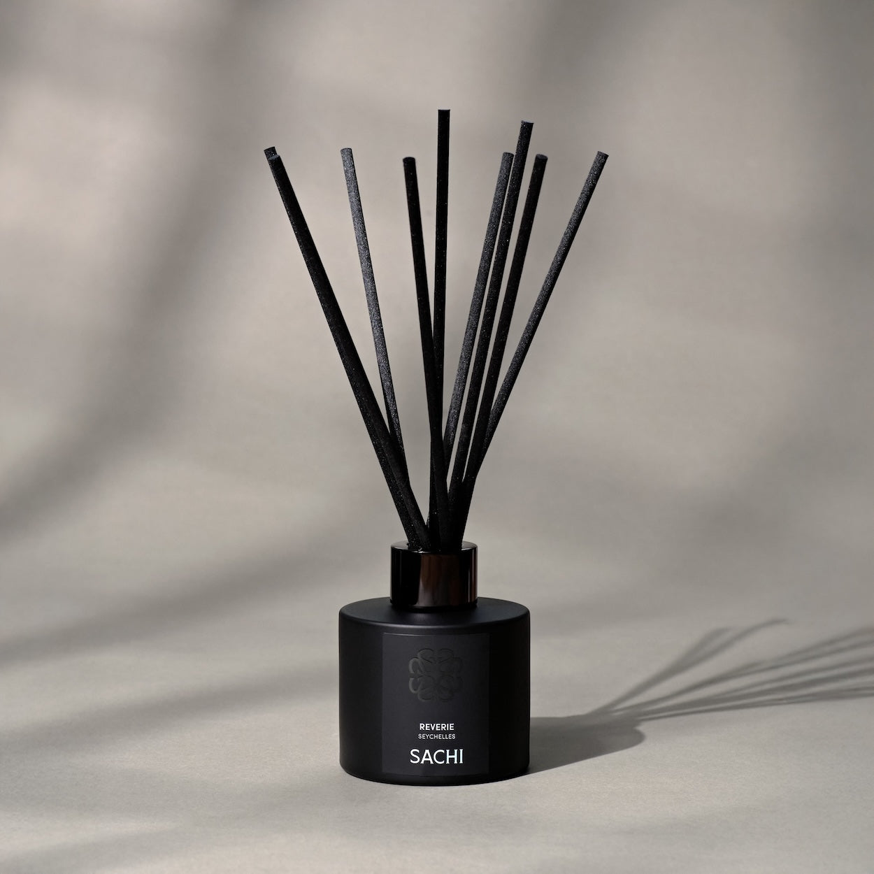 Sachi branded reed diffuser in black on a neutral background