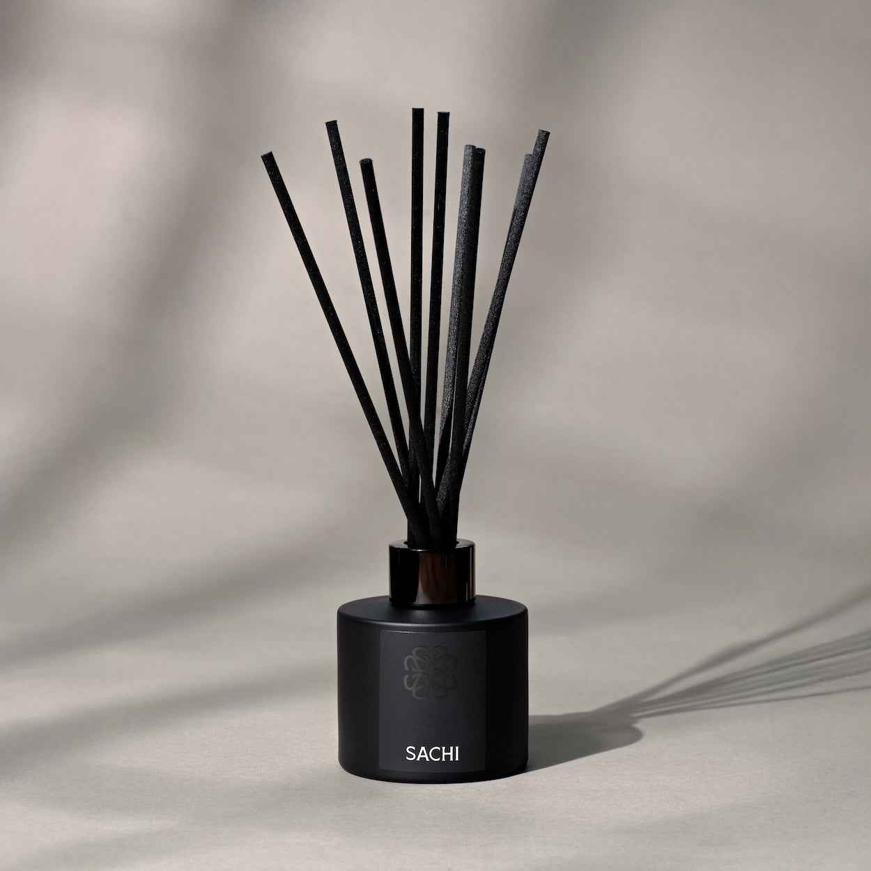 Black Sachi branded reed diffuser on a neutral background