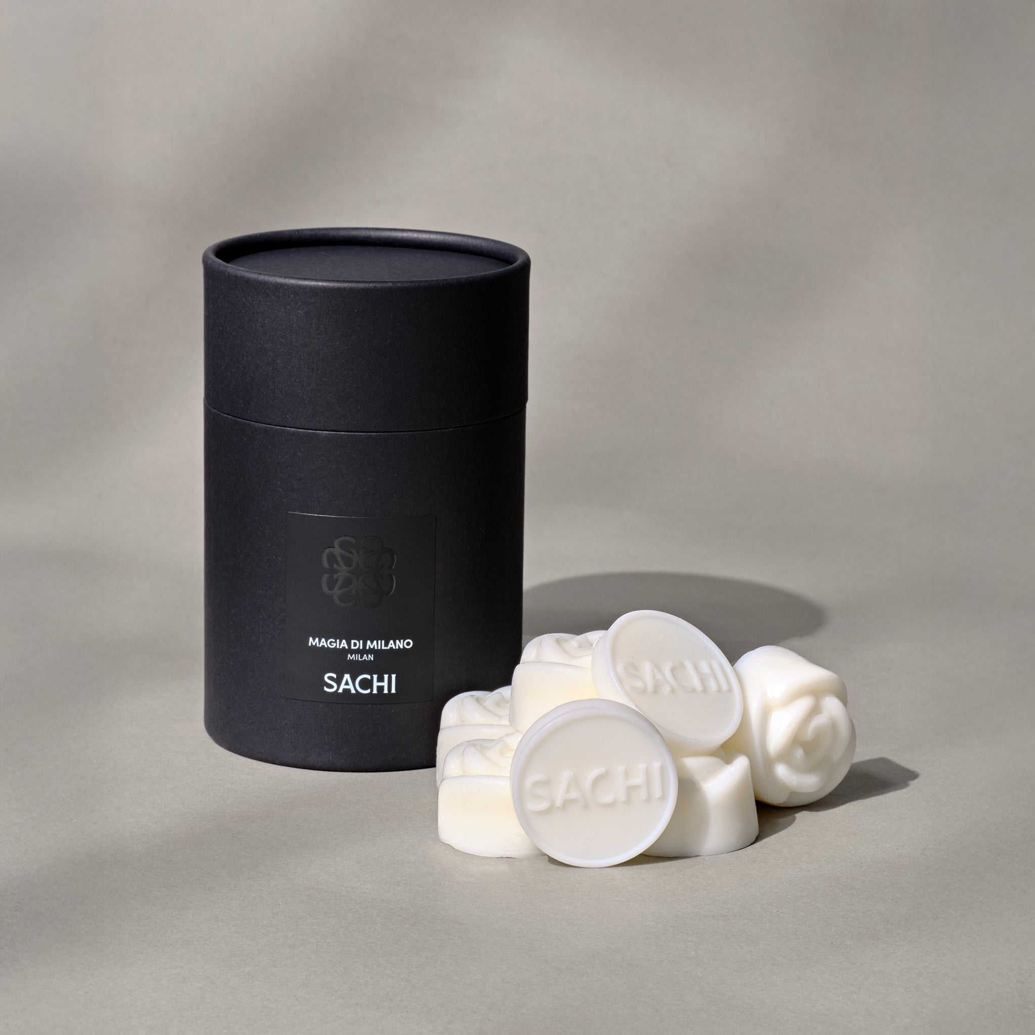 Black branded gift box with ivory rose shaped wax melts