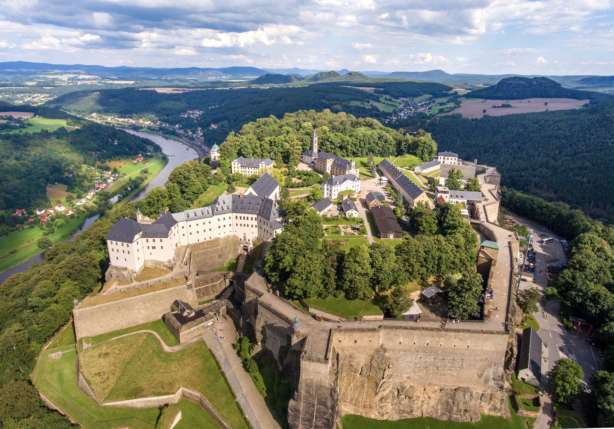 An aerial view of Saony showing fortress walls with a river below.