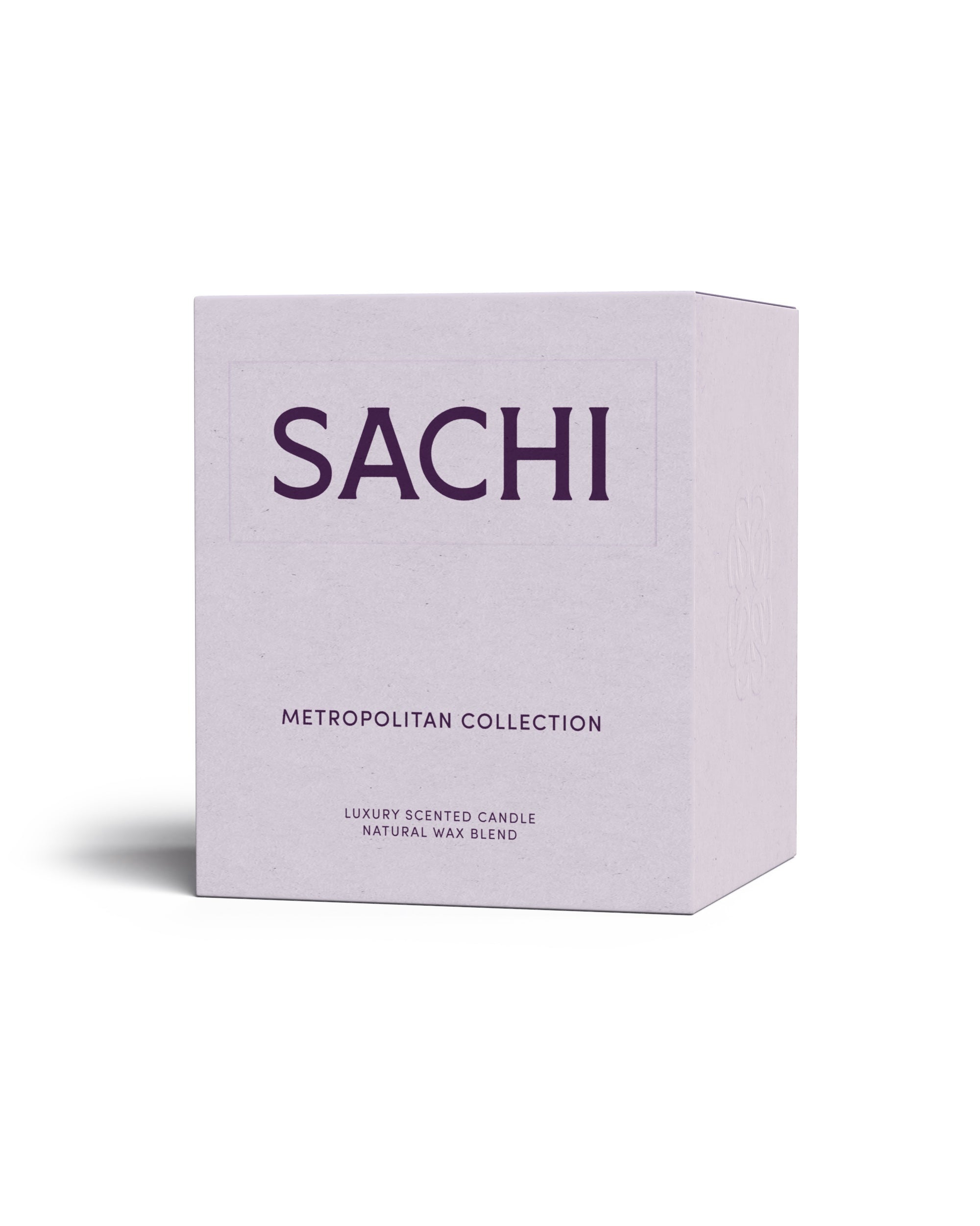 A rectangular cardboard candle box in mauve branded SACHI and belonging to the Metropolitan Candle Collection. On a white background.